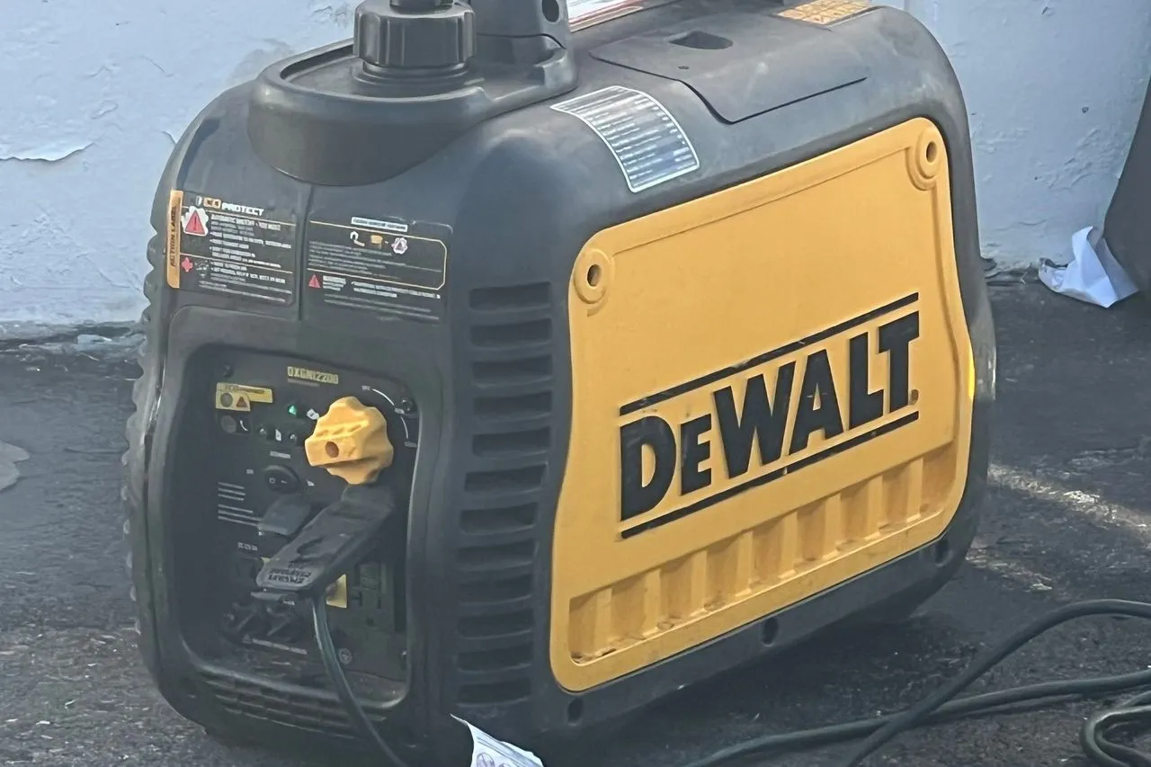 Portable gas generator with a CO Protect auto shut-off label, sitting outdoors
