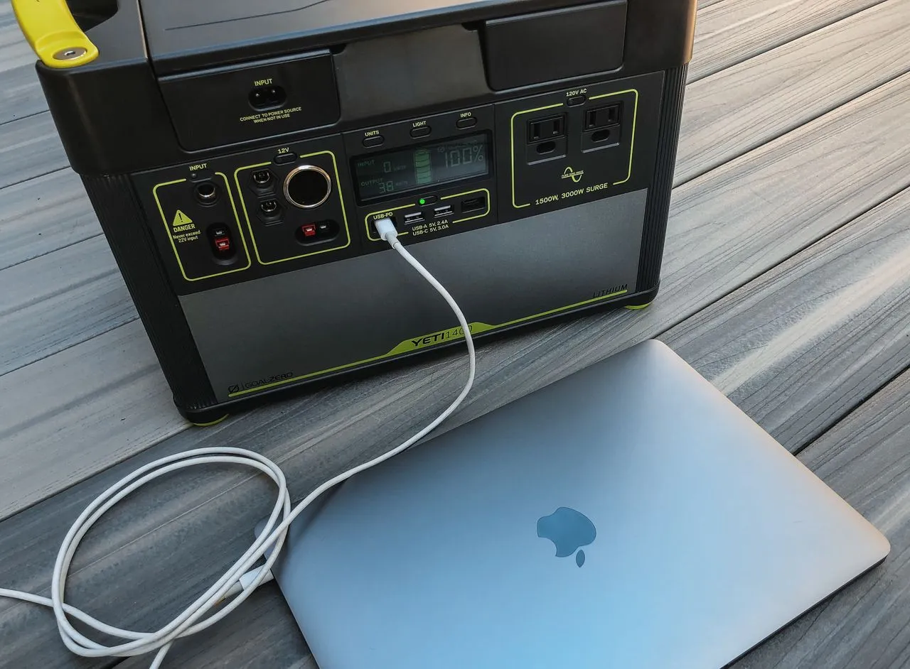 Portable power station on a home table powering a laptop over USB-C
